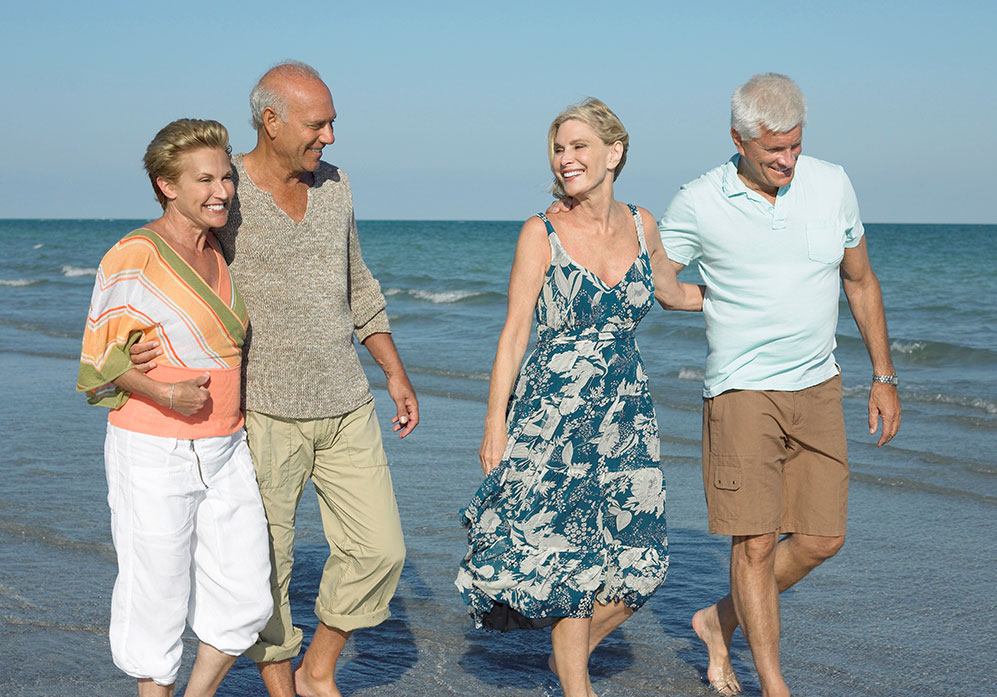 Friends walking on a beach together