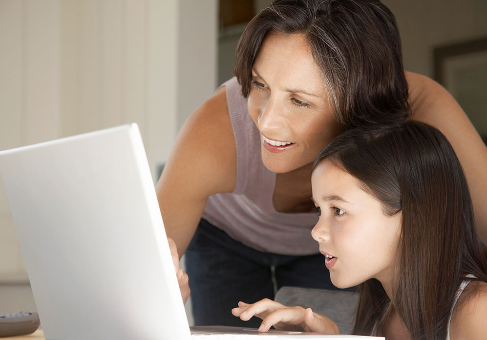 Mother and Daughter researching using a computer